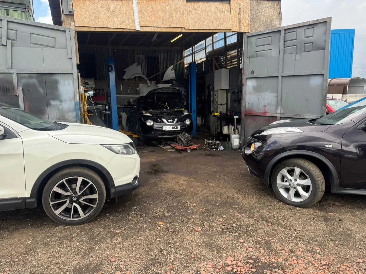 Mechanic working in a warm garage bay on a lifted pickup truck